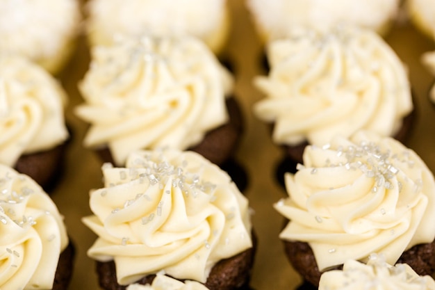 Fresh cupcakes with white icing in the box.