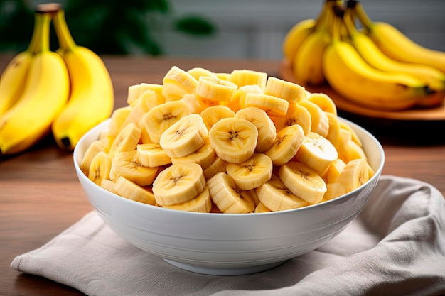 fresh cut bananas in a white bowl on wooden table