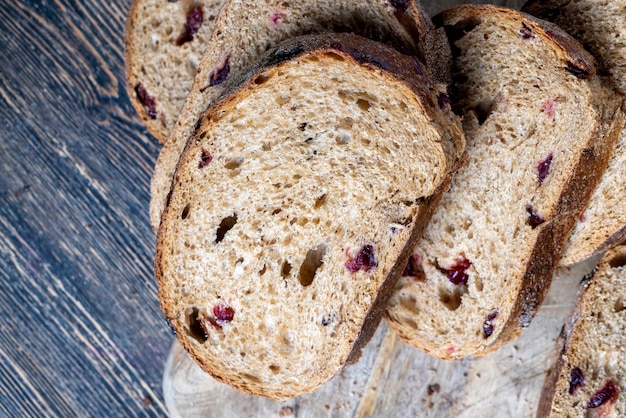 Fresh cut bread made of flour and dried cranberries