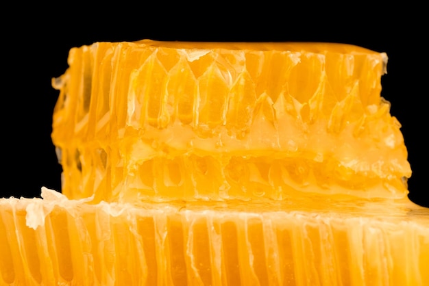 Fresh cut comb honey isolated on black