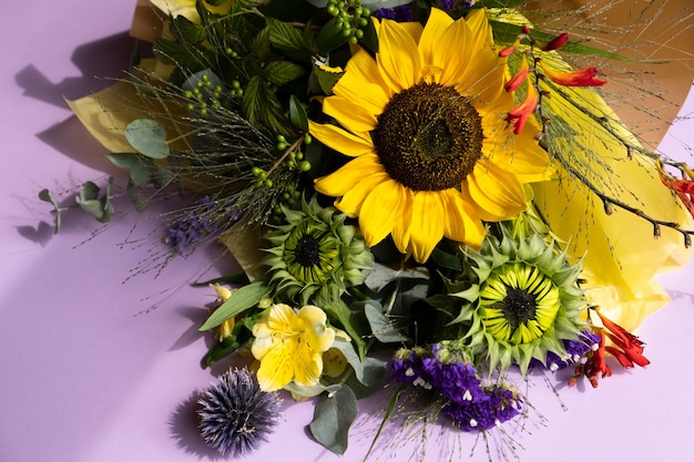 Fresh cut sunflowers in bouquet on purple background