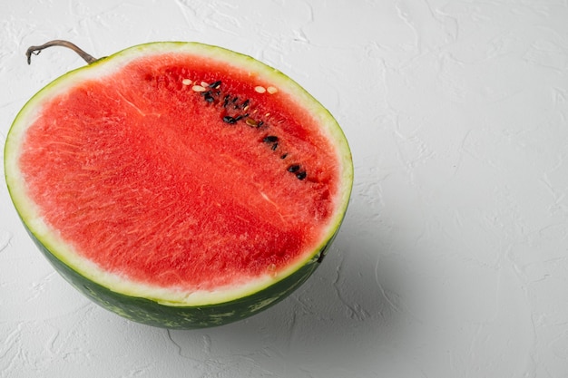 Fresh cut watermelon set, on white stone table background, with copy space for text