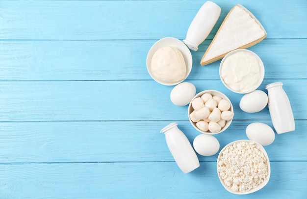 Fresh dairy products and eggs on wooden background