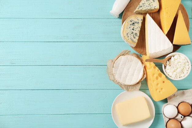 Fresh dairy products and eggs on wooden background