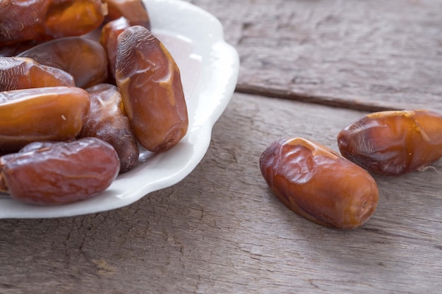 Fresh dates over wooden background