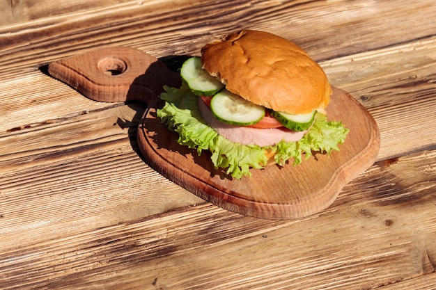 Fresh delicious homemade burger on wooden table