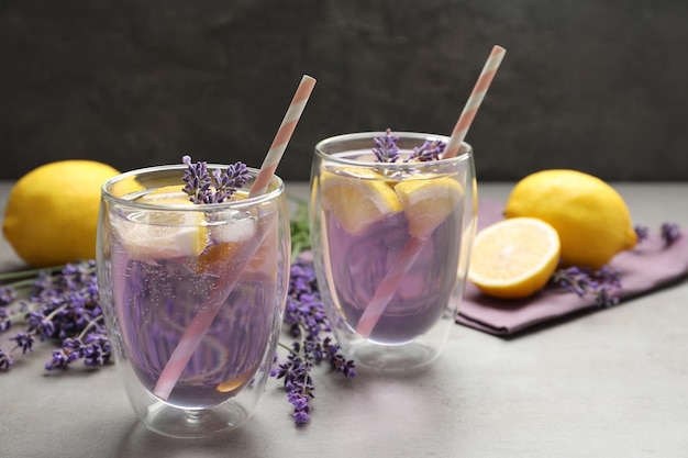 Fresh delicious lemonade with lavender on grey table