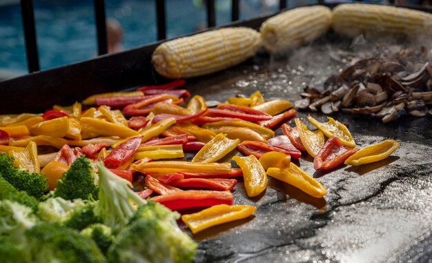 Fresh and delicious paper broccoli corn and muchrooms on grill summer family meal on backyard