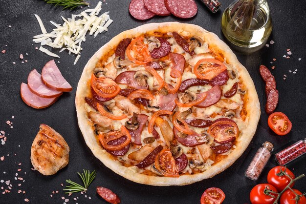 Fresh delicious pizza made in a hearth oven with sausage, pepper and tomatoes. Mediterranean cuisine