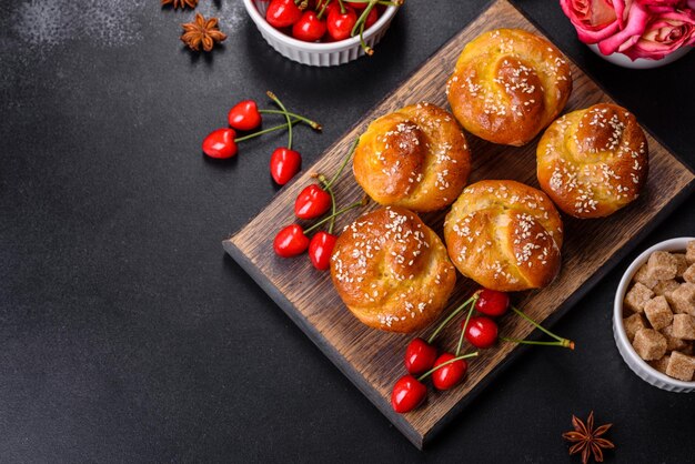 Fresh delicious rice flour muffins with cherries on a concrete background Homemade pastries