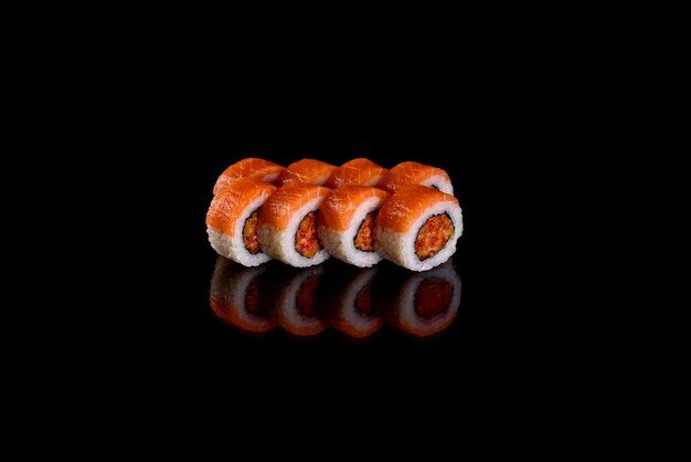 Fresh delicious sushi rolls on a dark background