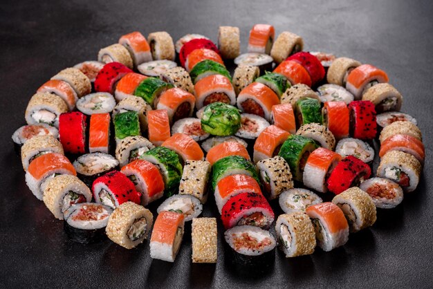 Fresh delicious sushi rolls on a dark background