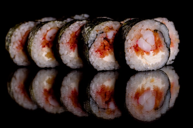 Fresh delicious sushi rolls on a dark background