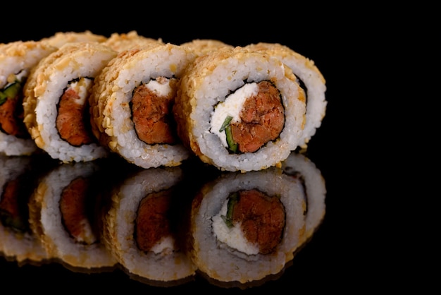 Fresh delicious sushi rolls on a dark background