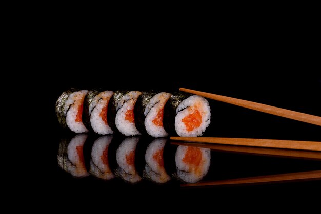 Fresh delicious sushi rolls on a dark background