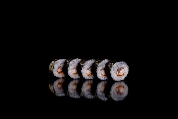 Fresh delicious sushi rolls on a dark background