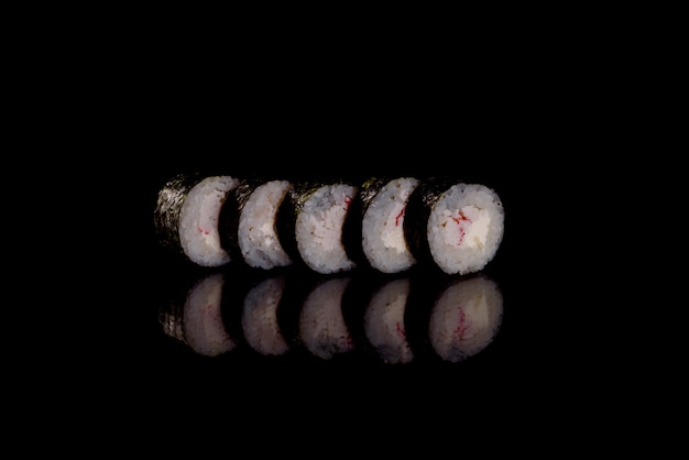 Fresh delicious sushi rolls on a dark background