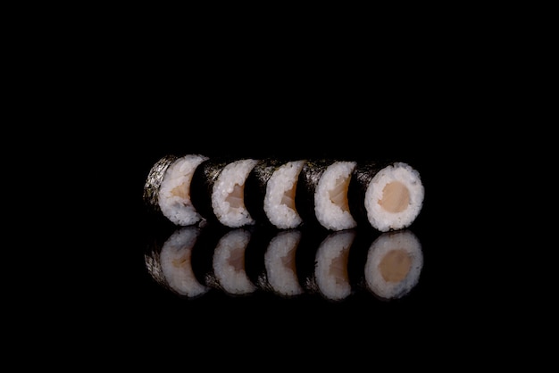 Fresh delicious sushi rolls on a dark background