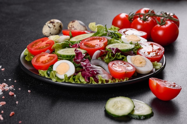 Fresh delicious vegitarian salad of chopped vegetables on a plate on a dark concrete background