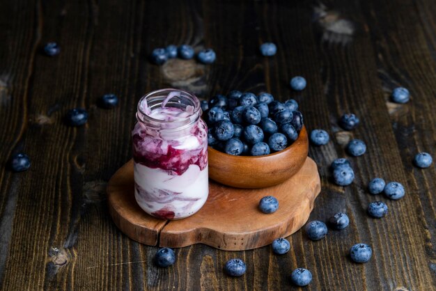 Fresh delicious yogurt made from milk with blueberry flavor yogurt with fresh berries and blueberry jam