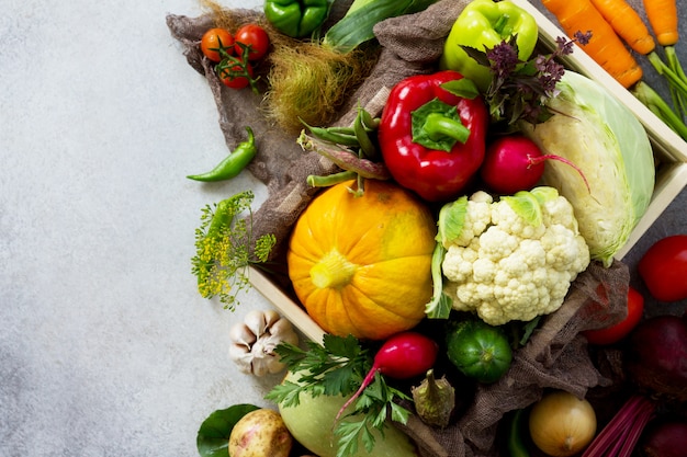 Fresh different vegetables in a wooden box