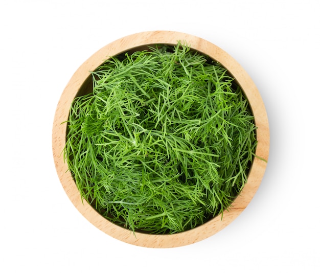 Fresh dill in wood bowl isolated