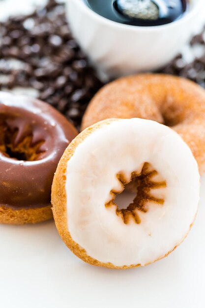 Fresh donuts with coffee on a white background.