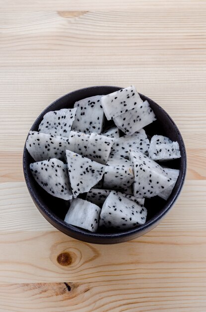 Fresh dragon fruits slices in black bowl