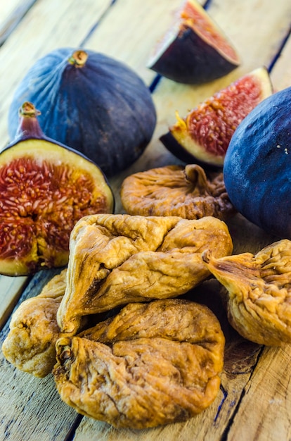 Fresh and dried figs on a wooden table