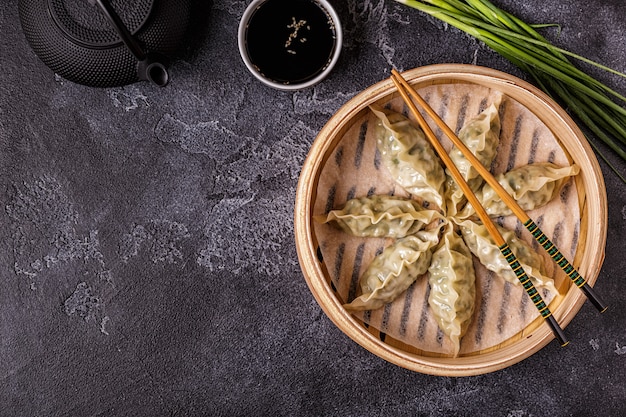 Fresh dumplings on a dark stone background