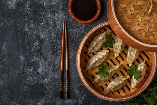 Fresh dumplings on a dark stone surface