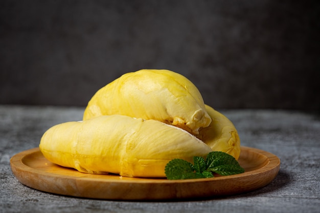 Fresh durian fruit on the dark surface.