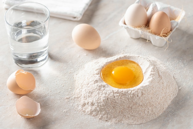 Fresh egg in a heap of whole grain flour