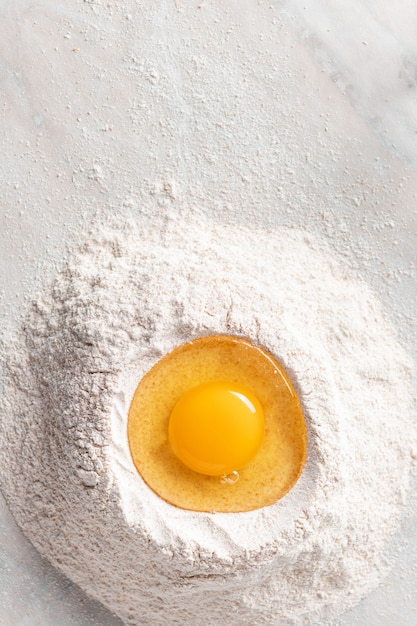 Fresh egg in heap of wholemeal flour