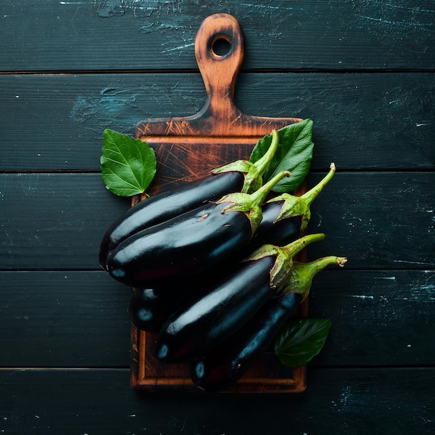Fresh eggplant on black background Vegetables Top view Free copy space