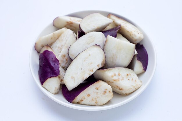 Fresh eggplant in plate on white background.