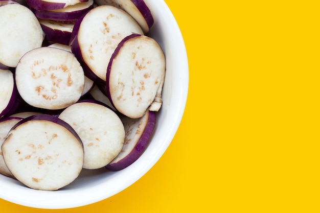 Fresh eggplant in white bowl