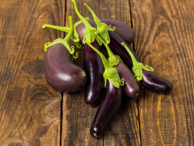 Fresh eggplant on a wooden background closeup