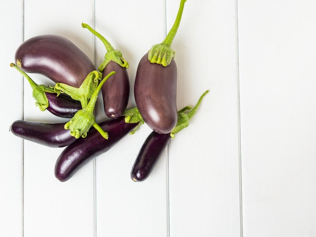 Fresh eggplant on a wooden background closeup