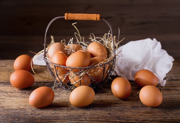 Fresh eggs in a basket on wooden table