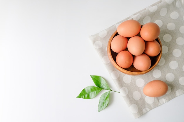 Fresh eggs from the farm placed on a white wooden table background