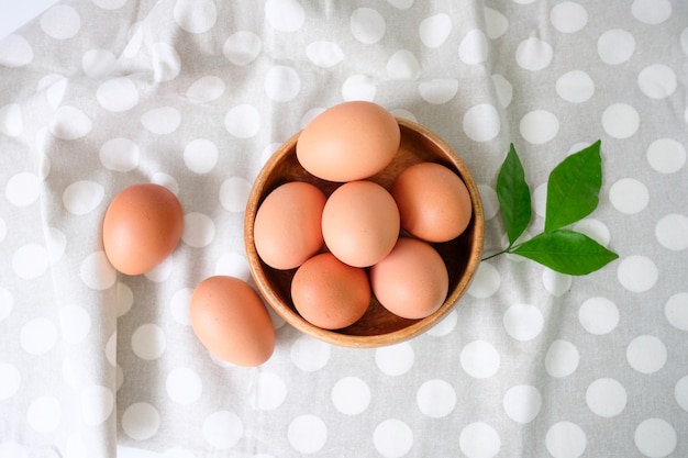 Fresh eggs from the farm placed on a white wooden table background