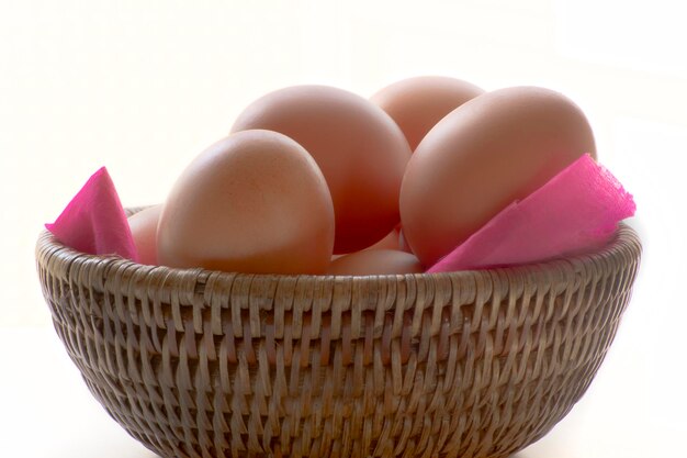 Fresh eggs on pink paper