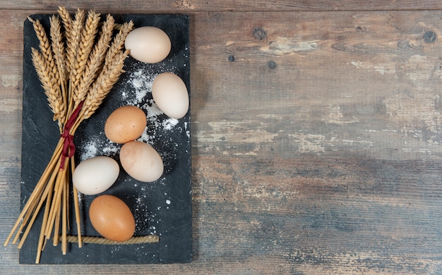 Fresh eggs and some wheat ears