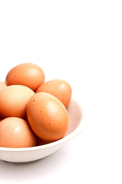 Fresh eggs in a white bowl with copy space