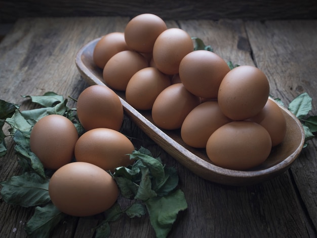 fresh eggs on wooden table.