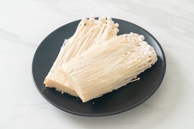 Fresh enoki mushroom or golden needle mushrooms on plate