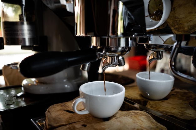 Photo fresh espresso shot pouring out of machine