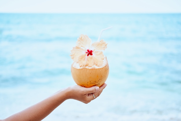 Fresh Exotic Coconut Water Drink in Woman Hand