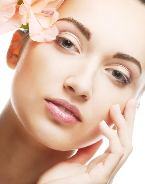 Fresh face with gladiolus flowers in her hands